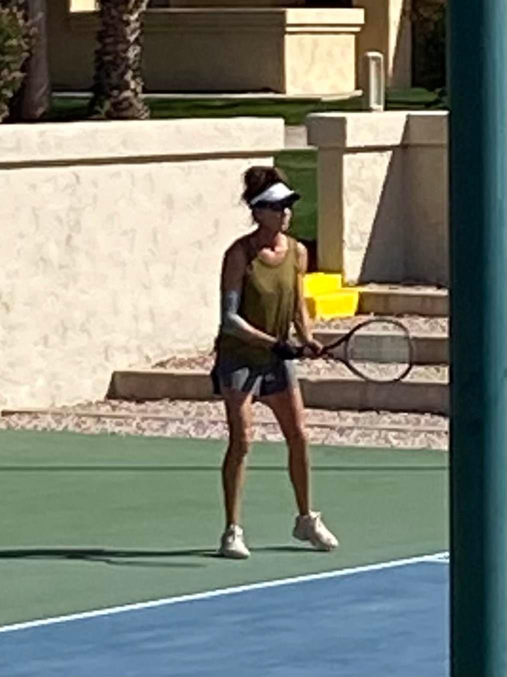 A player holding a racquet in a ready position during the 2022 ladies open final.