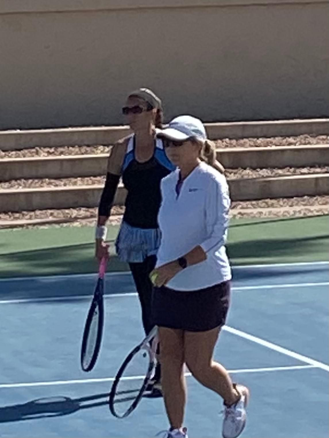 Two players holding racquets on court during the 2022 ladies open final.