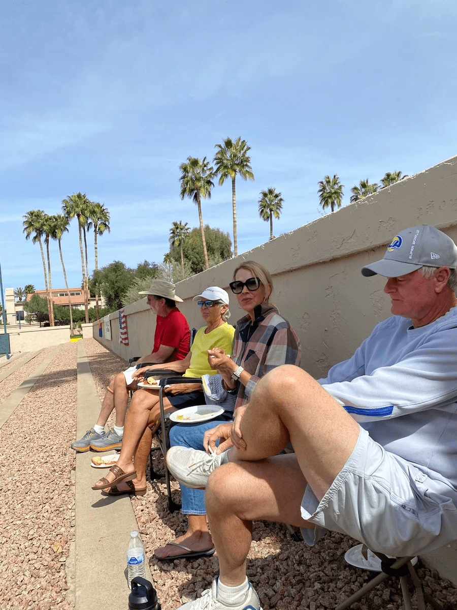 Spectators seated beside the court watching a tennis event.
