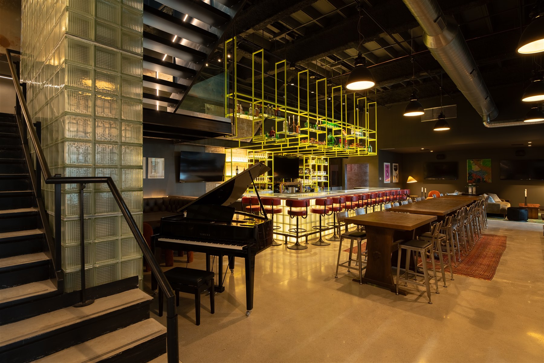 Piano, illuminated bar and communal tables at Neon Record