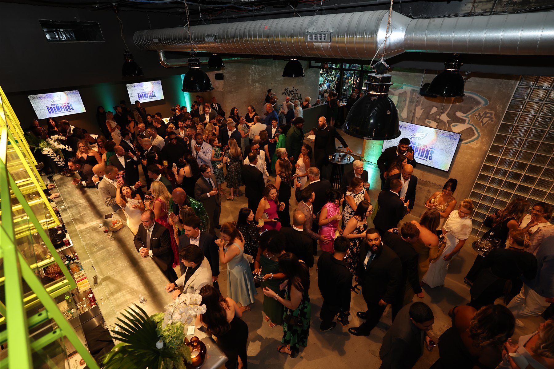 Guests gathering for a reception at the Neon Record bar