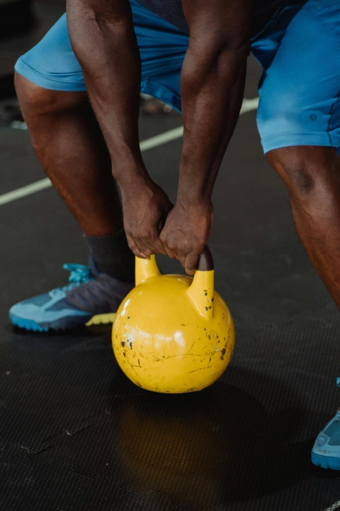 Athlete performing a kettlebell exercise during strength training at The Strength Yard in West Palm Beach, FL.