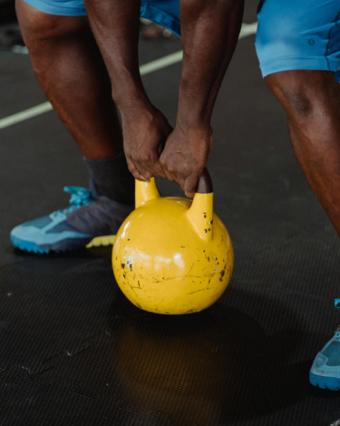 Athlete performing a kettlebell exercise during strength training at The Strength Yard in West Palm Beach, FL.