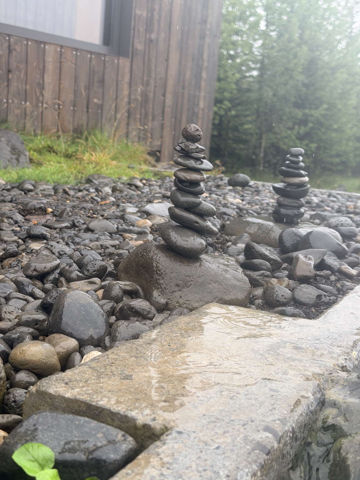 Small rock cairns beside a geothermal pool