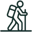 Icon of a person hiking with a backpack and walking stick.