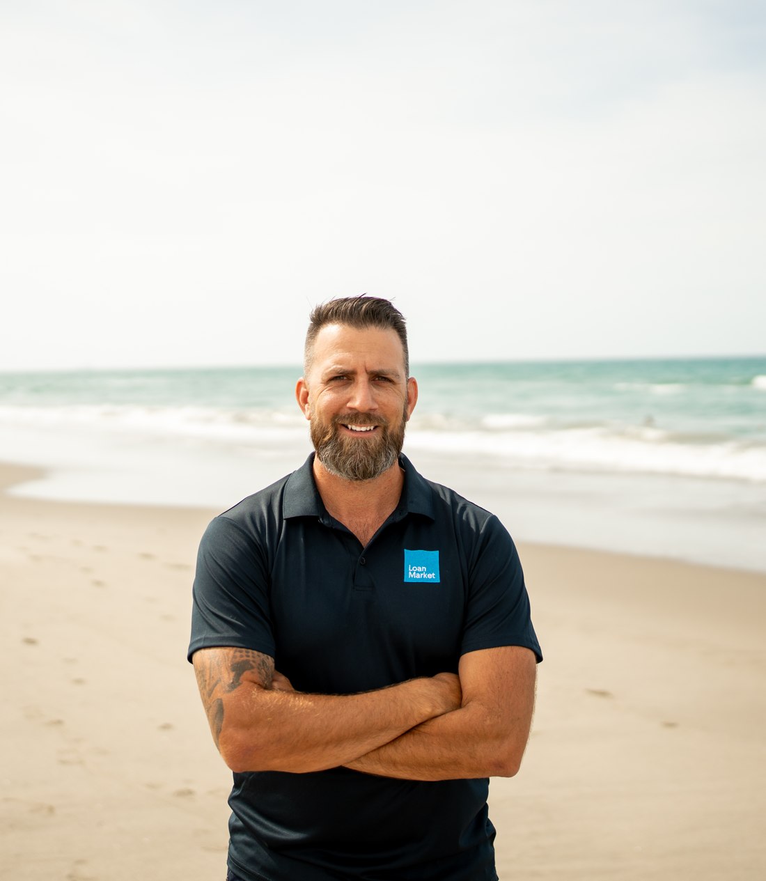 Dan Breed standing on Main Beach, Mount Maunganui