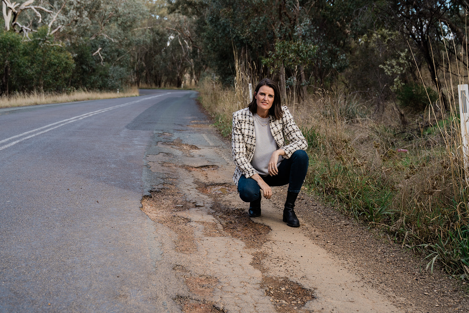 Annabelle Cleeland inspecting potholes on a local road