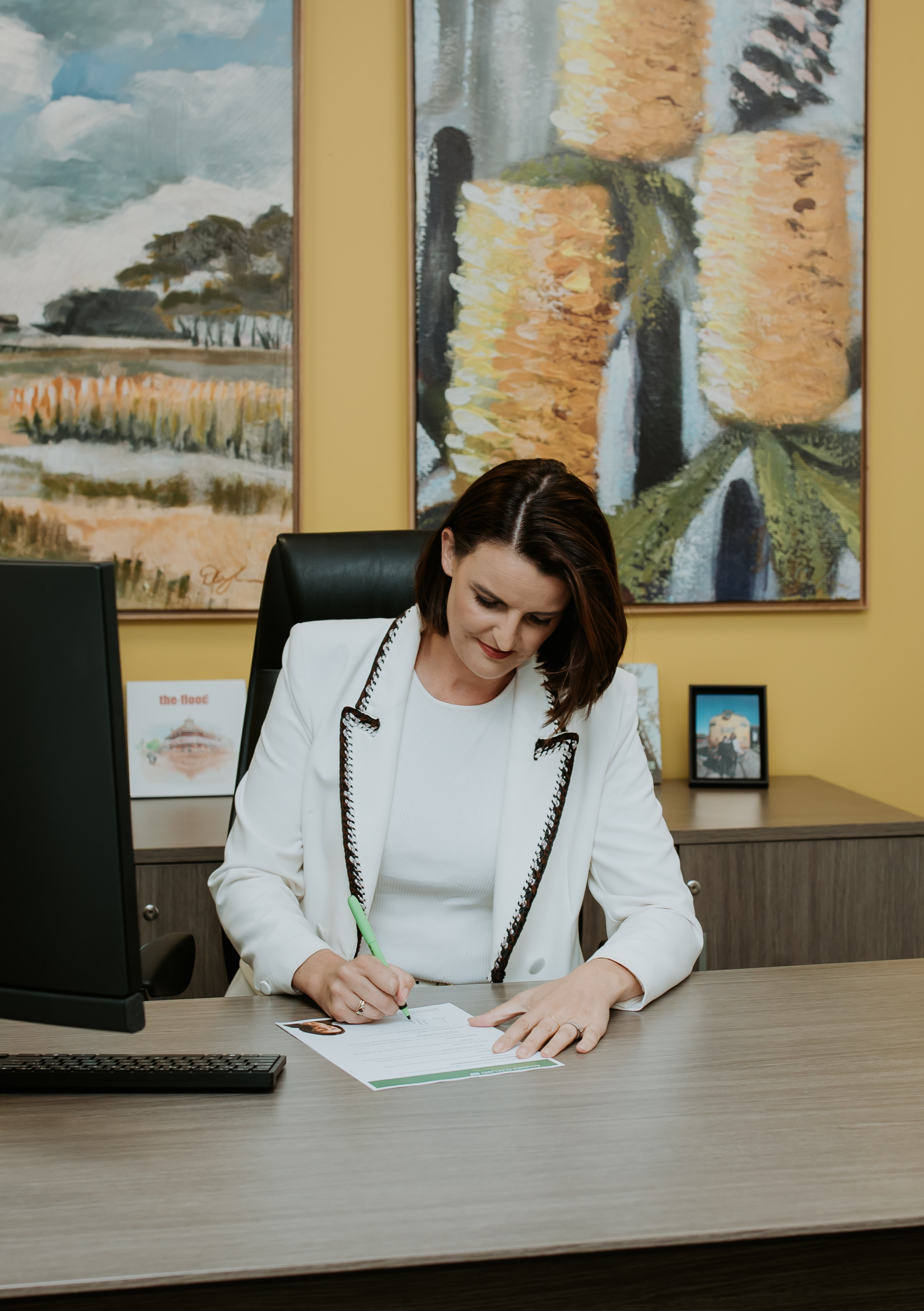 Annabelle Cleeland signing a letter at her desk