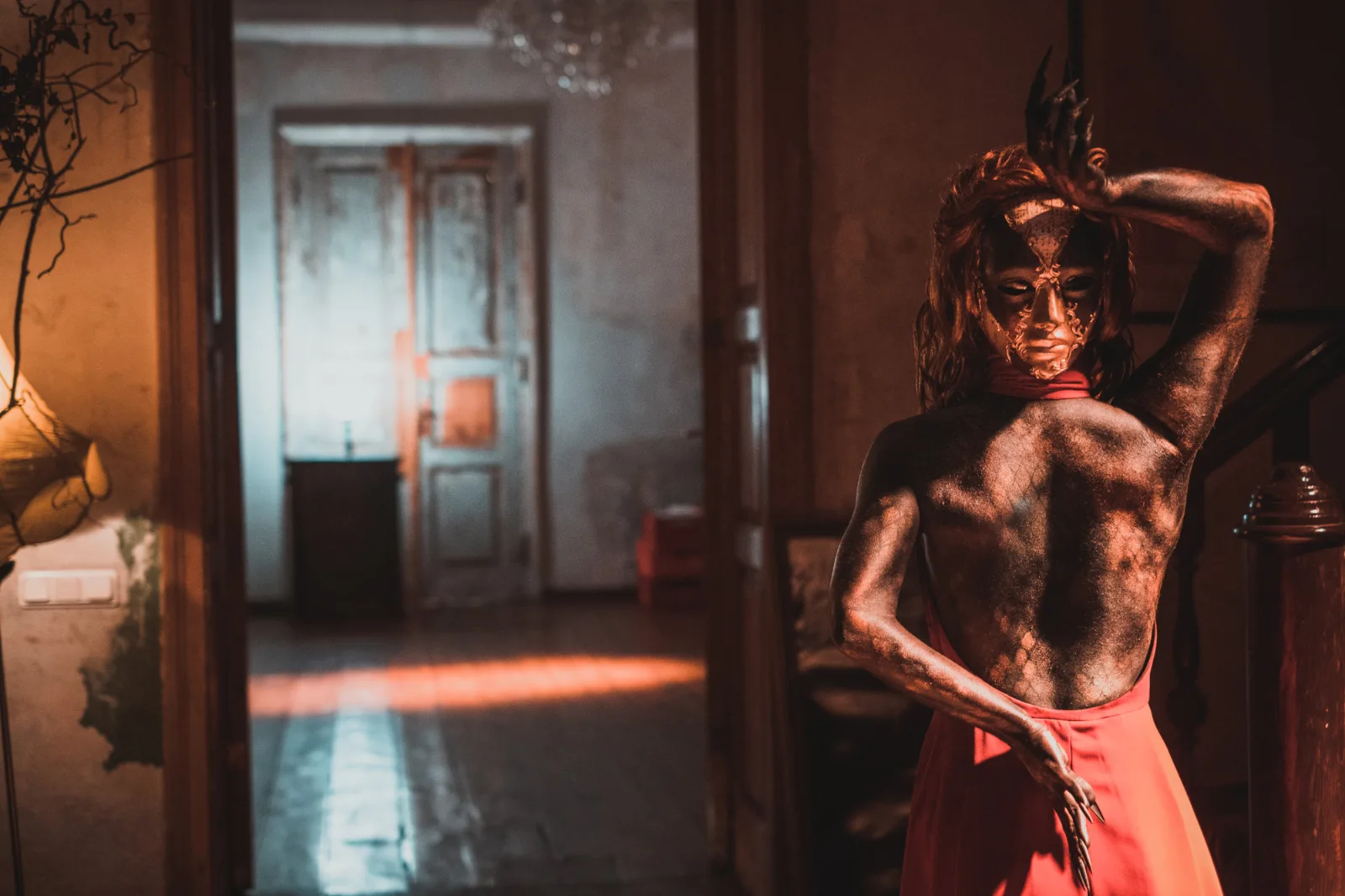 Your Dream – a figure with metallic body paint poses in an old room with tall doors