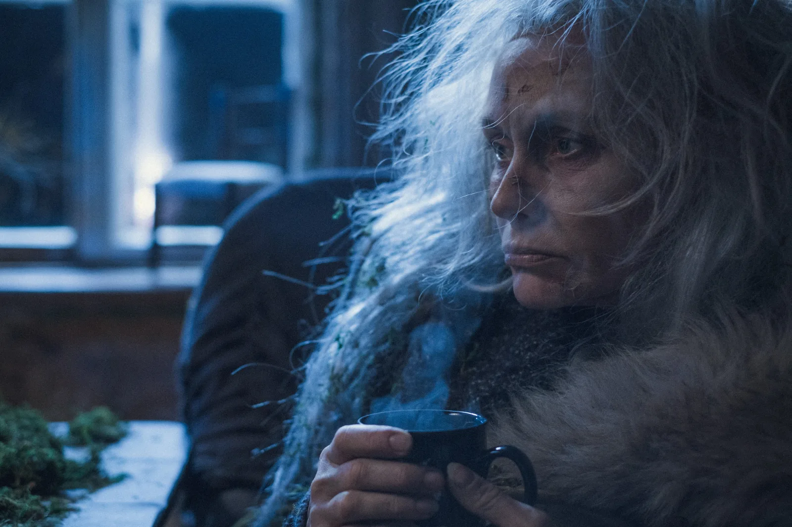 Your Dream – an older woman with long grey hair in a fur coat looks to the side