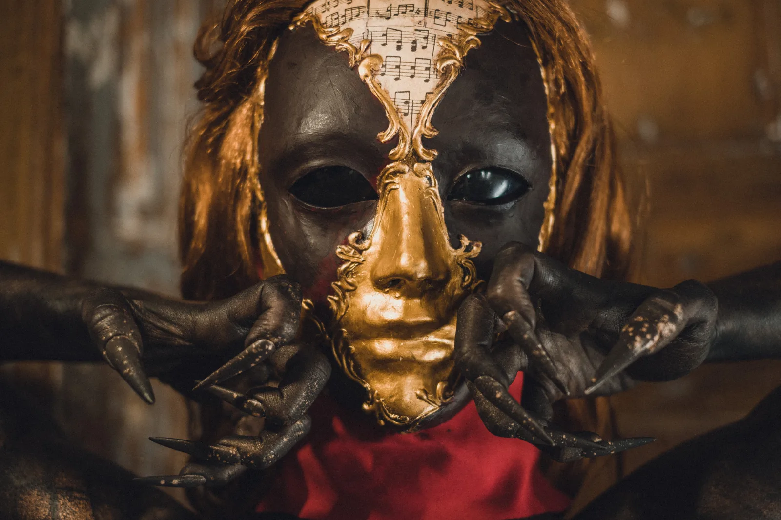Your Dream – a face hidden behind a cracked silver mask, framed by long fingers
