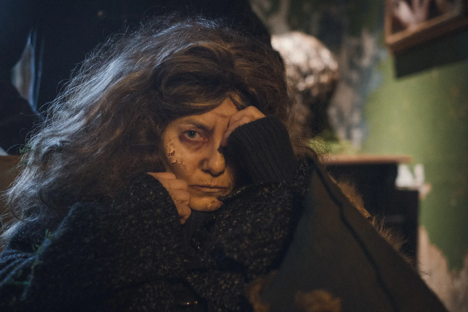 Your Dream – a woman with tangled hair covers one eye with her hand