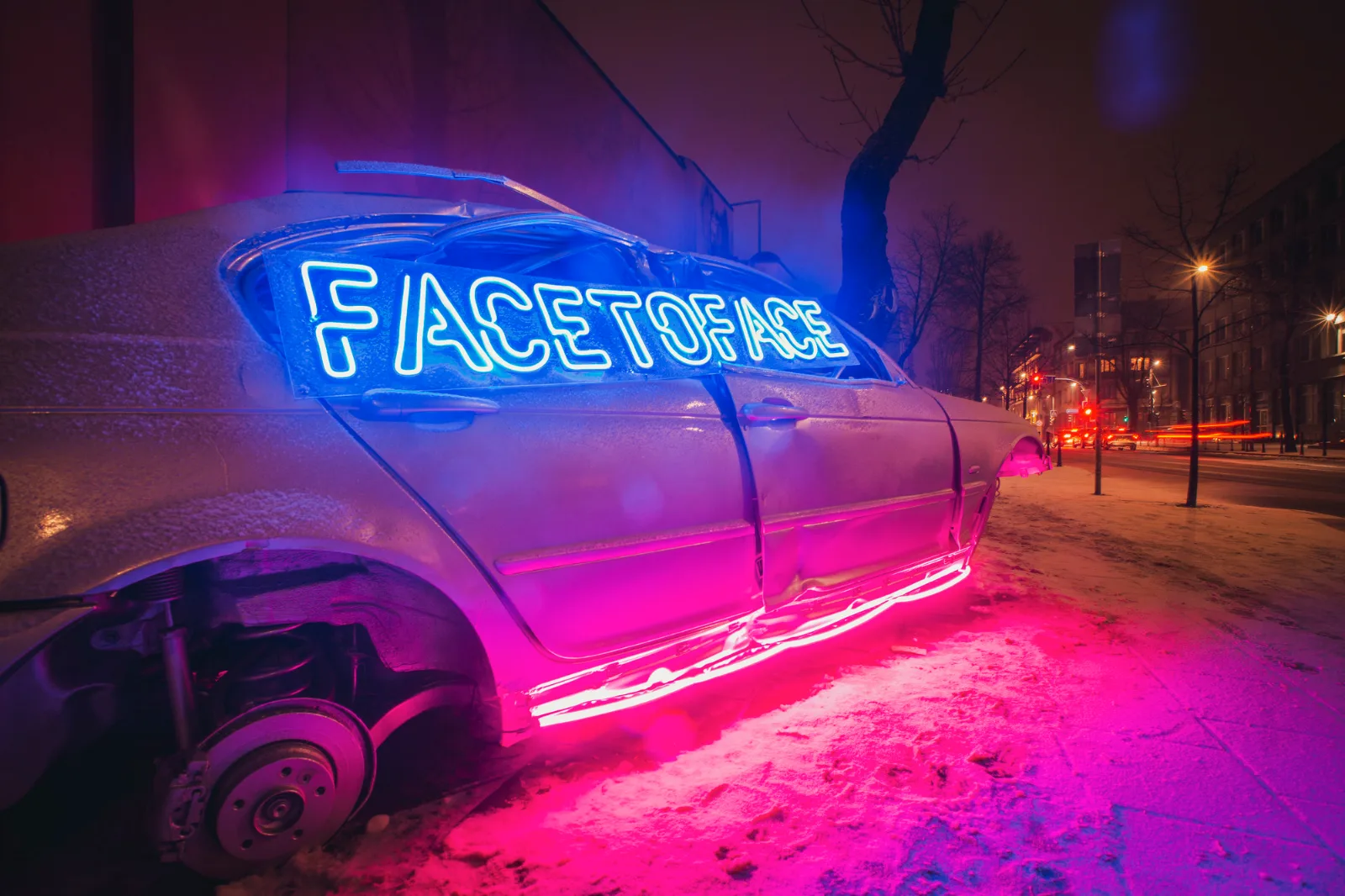 Kosmos Car – a wrecked car with glowing FACETOFACE lettering in the snow