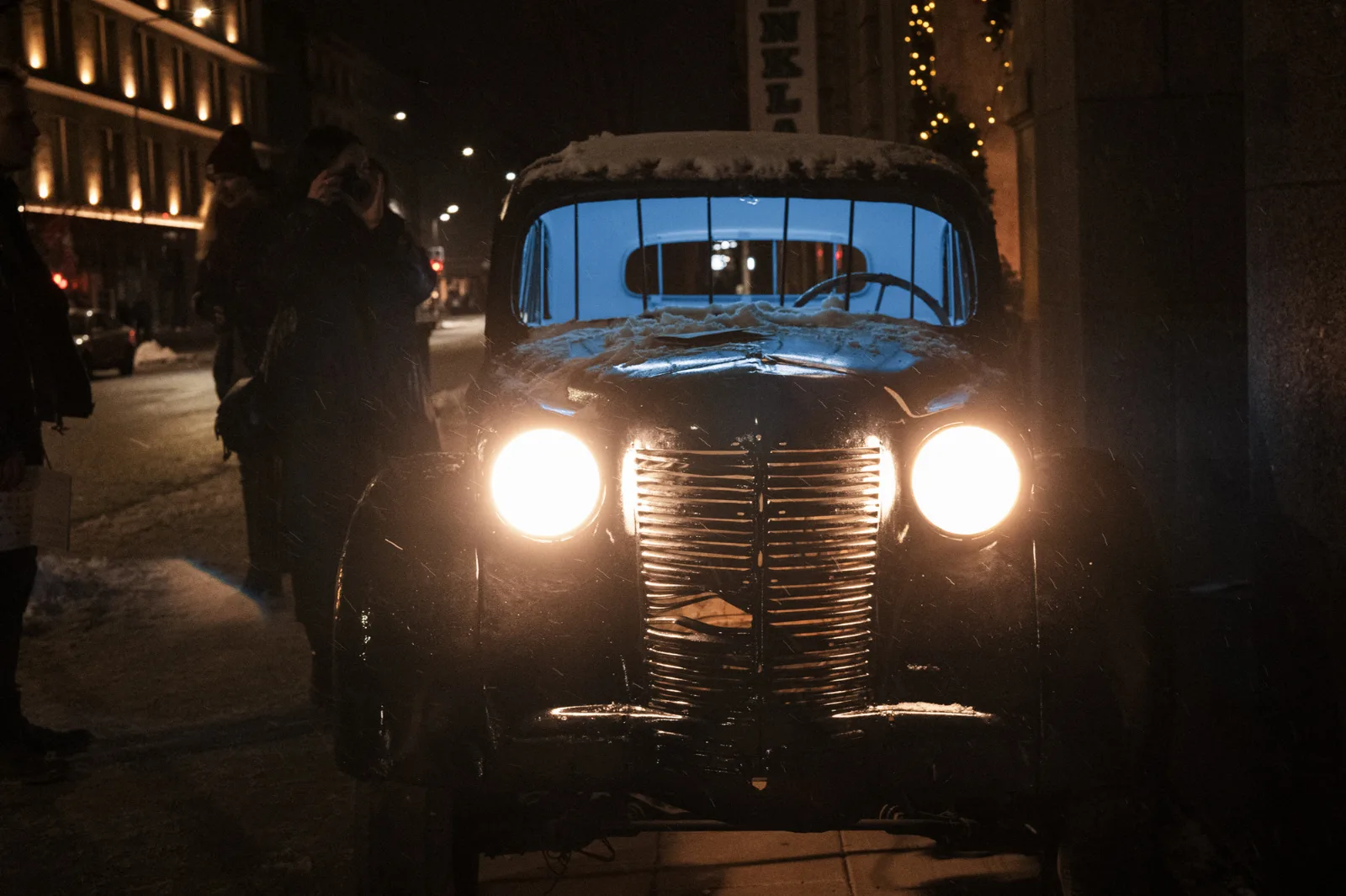 Kosmos Car – a vintage car with headlights on in a night street