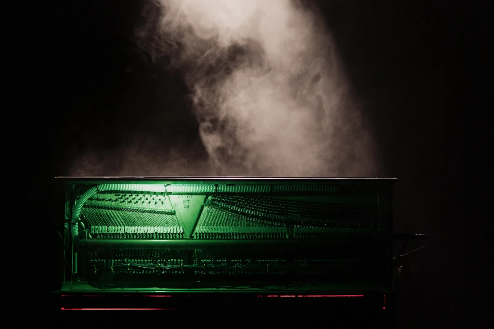 Piano and Furniture – an open upright piano in a cloud of haze