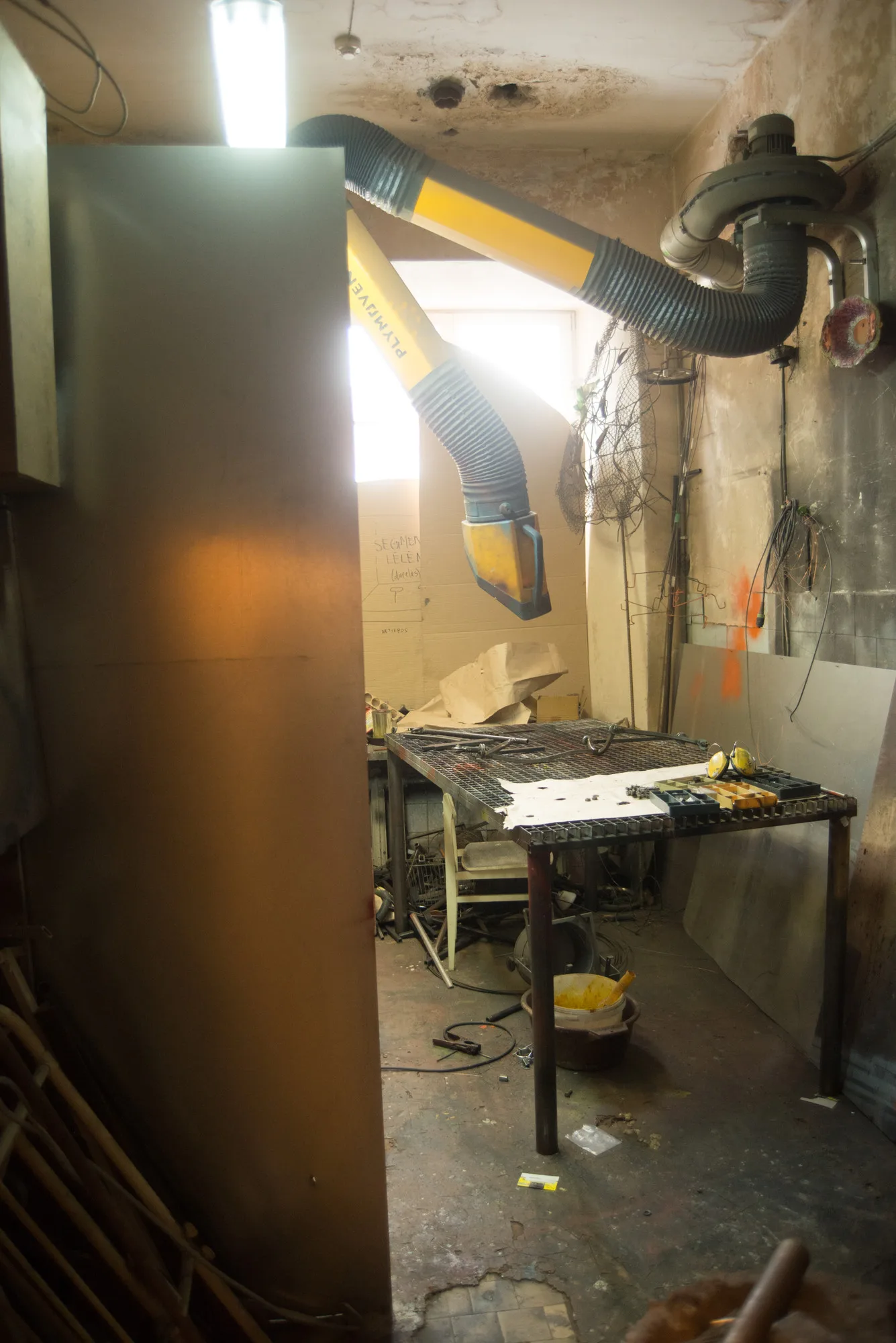 Lila – a workshop with a metal table and an extractor pipe
