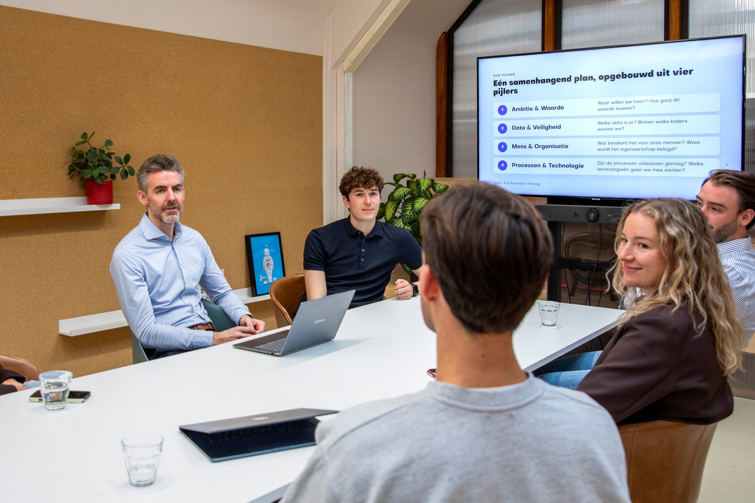 VionA discussing the four pillars of an AI strategy with a team at a table
