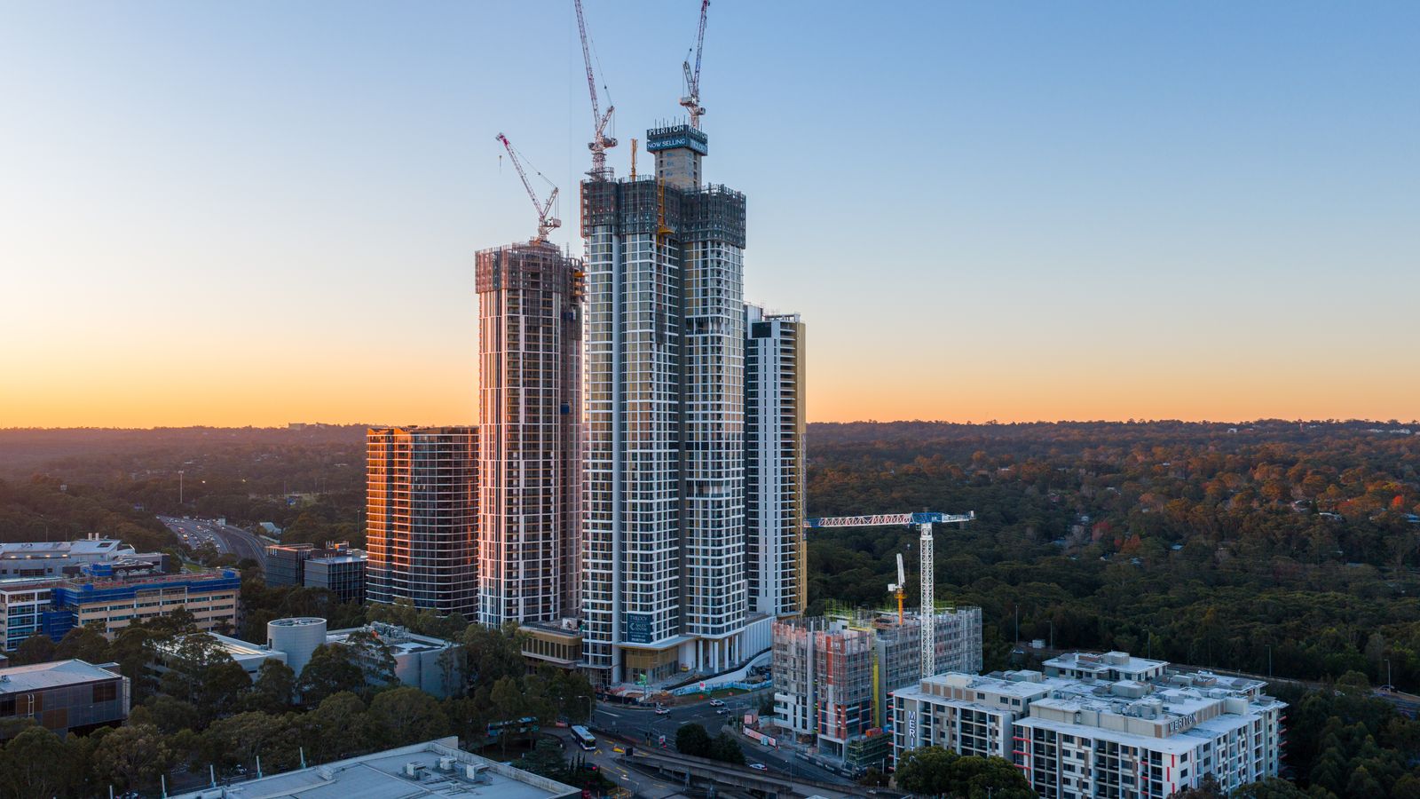 High-rise construction in Sydney at sunset.
