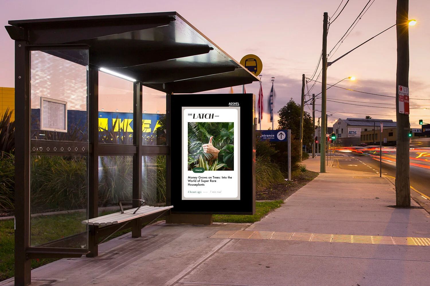 The Latch on an Adshel bus shelter screen at dusk
