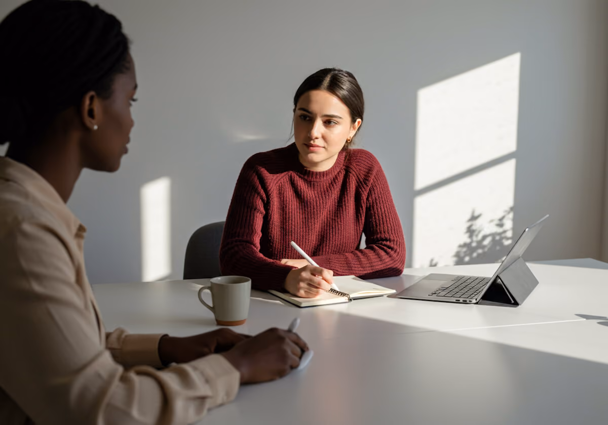 Businesswoman in a brown dress discussing a project with her client.