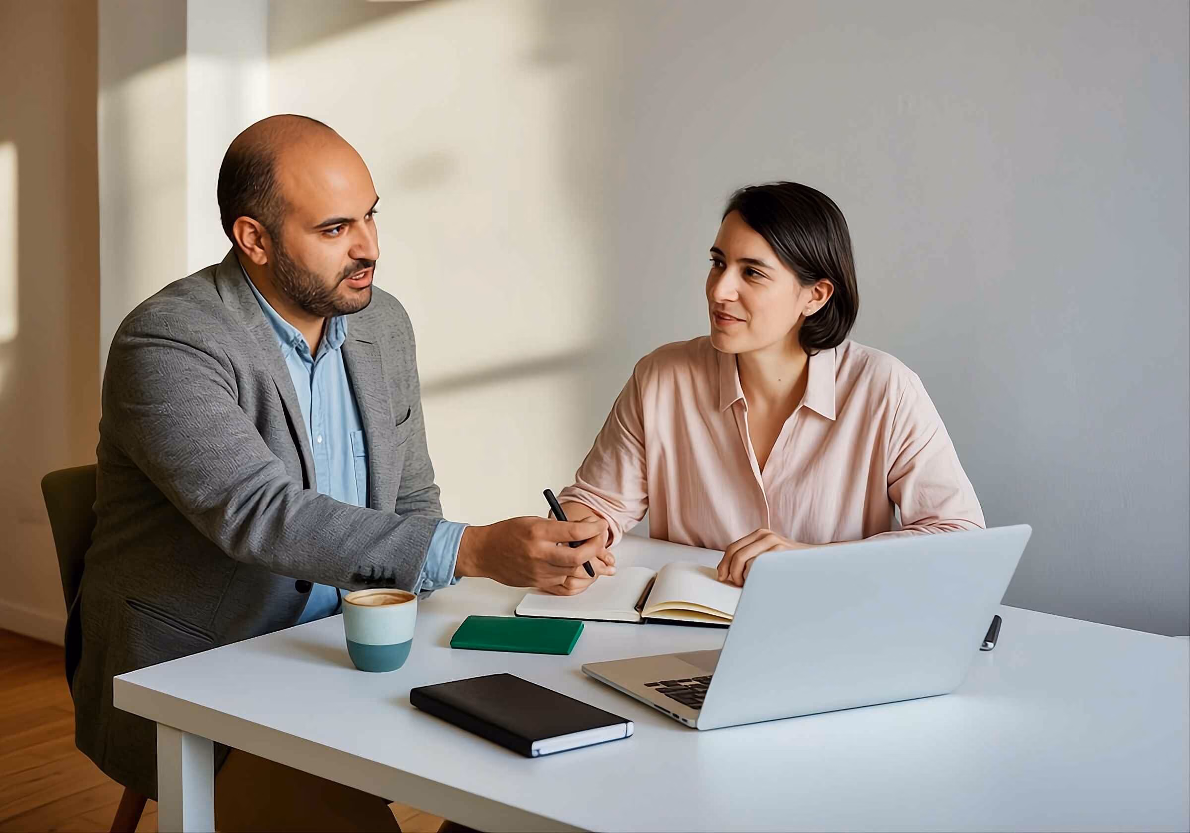Senior business consultant discussing a project with a junior consultant.