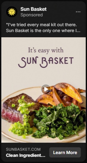 Sponsored Sun Basket ad showing a plate with sliced steak topped with chopped green onions, cooked greens, and roasted potato wedges, with text 'It's easy with Sun Basket' above the plate and a Learn More button below.