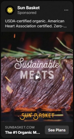 Sun Basket sponsored ad featuring close-up of a cooked steak with rosemary garnish, text overlay reading 'Sustainable Meats' and a play button icon, with promotional text about USDA-certified organic and American Heart Association certification.