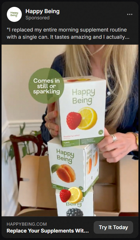 A person with long blonde hair holding three stacked boxes of Happy Being supplements, each featuring images of fruit like strawberry, lemon, and peach, with a green circle stating 'Comes in still or sparkling.'