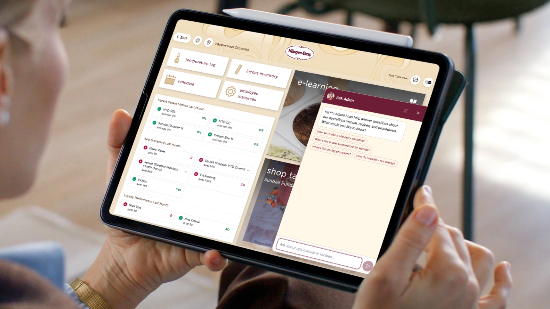 A person holds a tablet displaying a business management app with an AI assistant supporting inventory, employee resources, e-learning, and a chat feature visible on the screen.