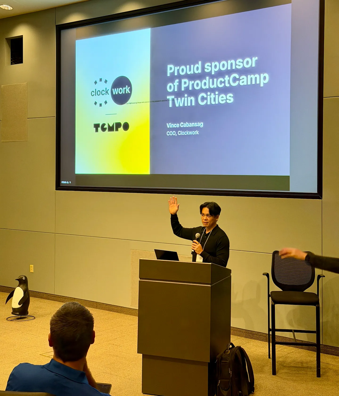 Clockwork COO Vince Cabansag addressing Product Camp Twin Cities at a conference held at Best Buy Headquarters. The screen behind him says Clockwork is a Proud Sponsor of Product Camp Twin Cities