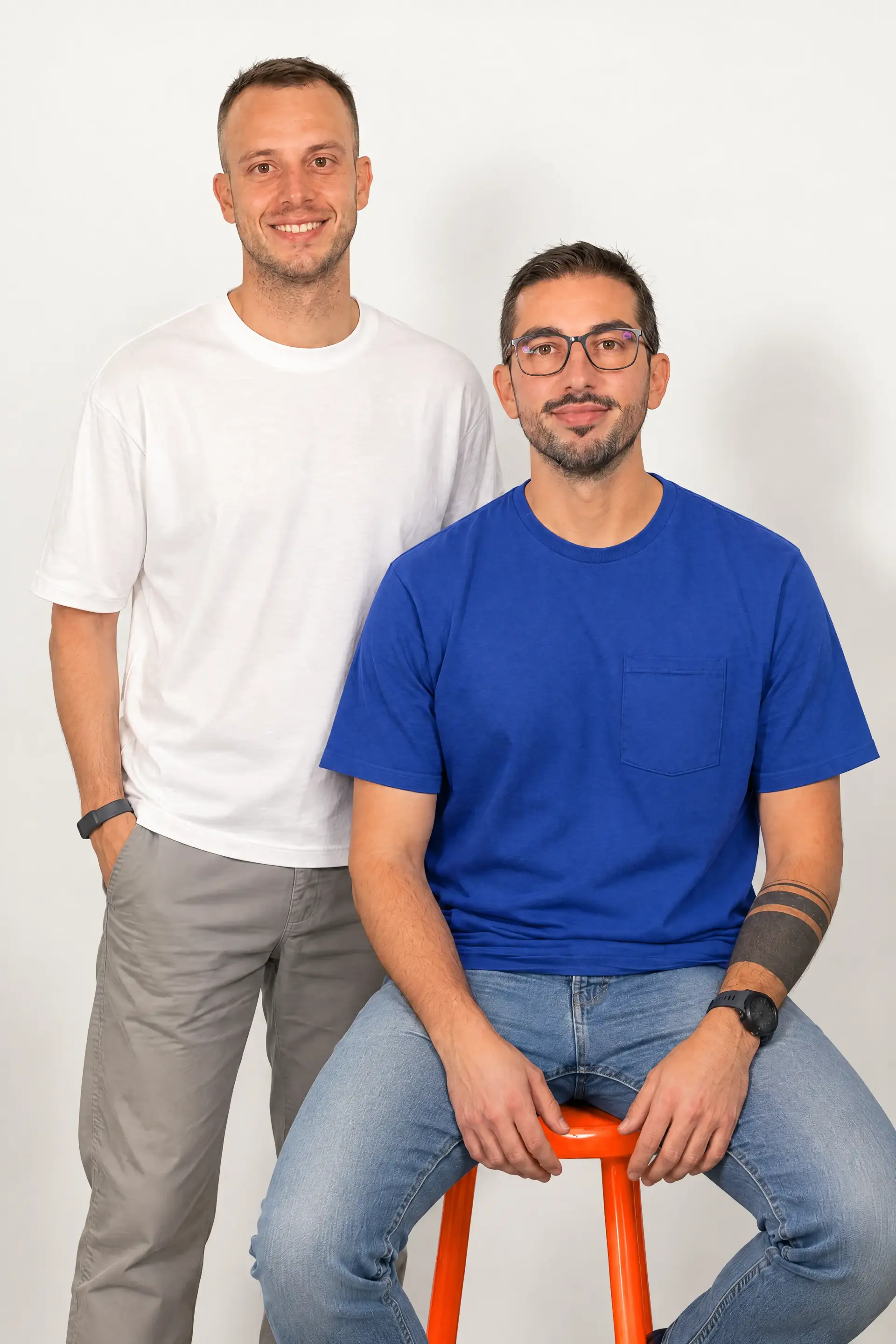 Two members of the Underdogs Group team in a studio portrait