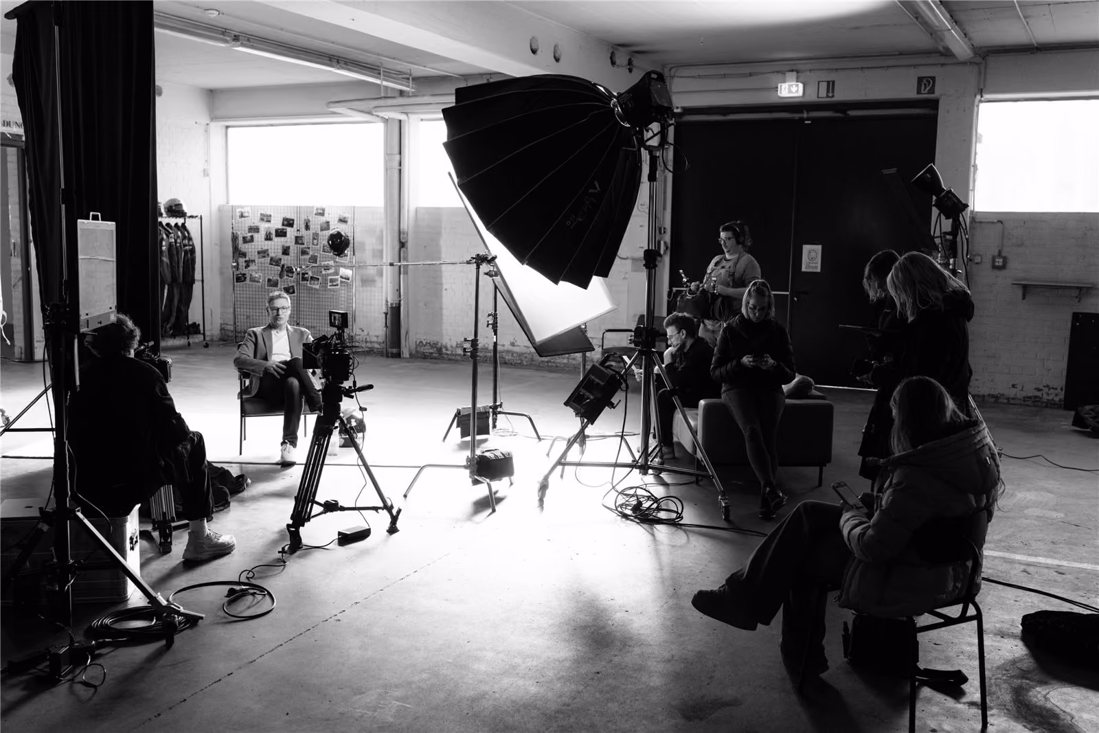 Interview set with lighting and crew in a bright studio hall