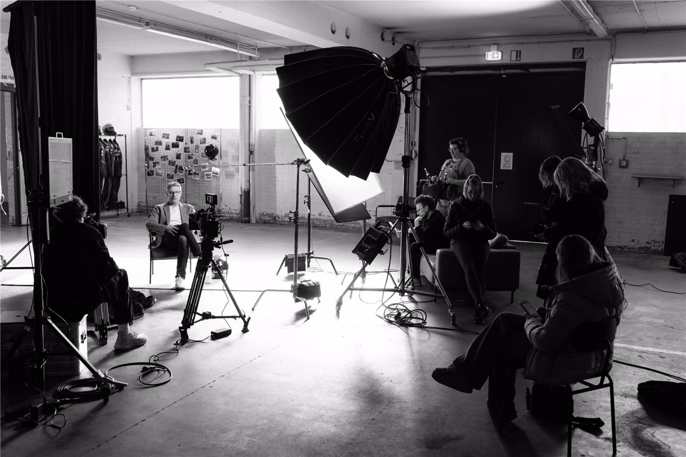 Production crew filming an interview in a studio hall