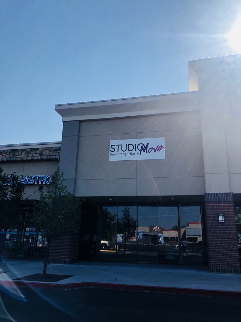 Studio Move signage and glass storefront next to Greek Bistro on N Glenwood St