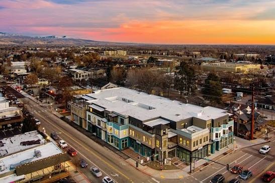 Aerial view of a new mixed-use building on State Street in downtown Eagle, Idaho, at sunset