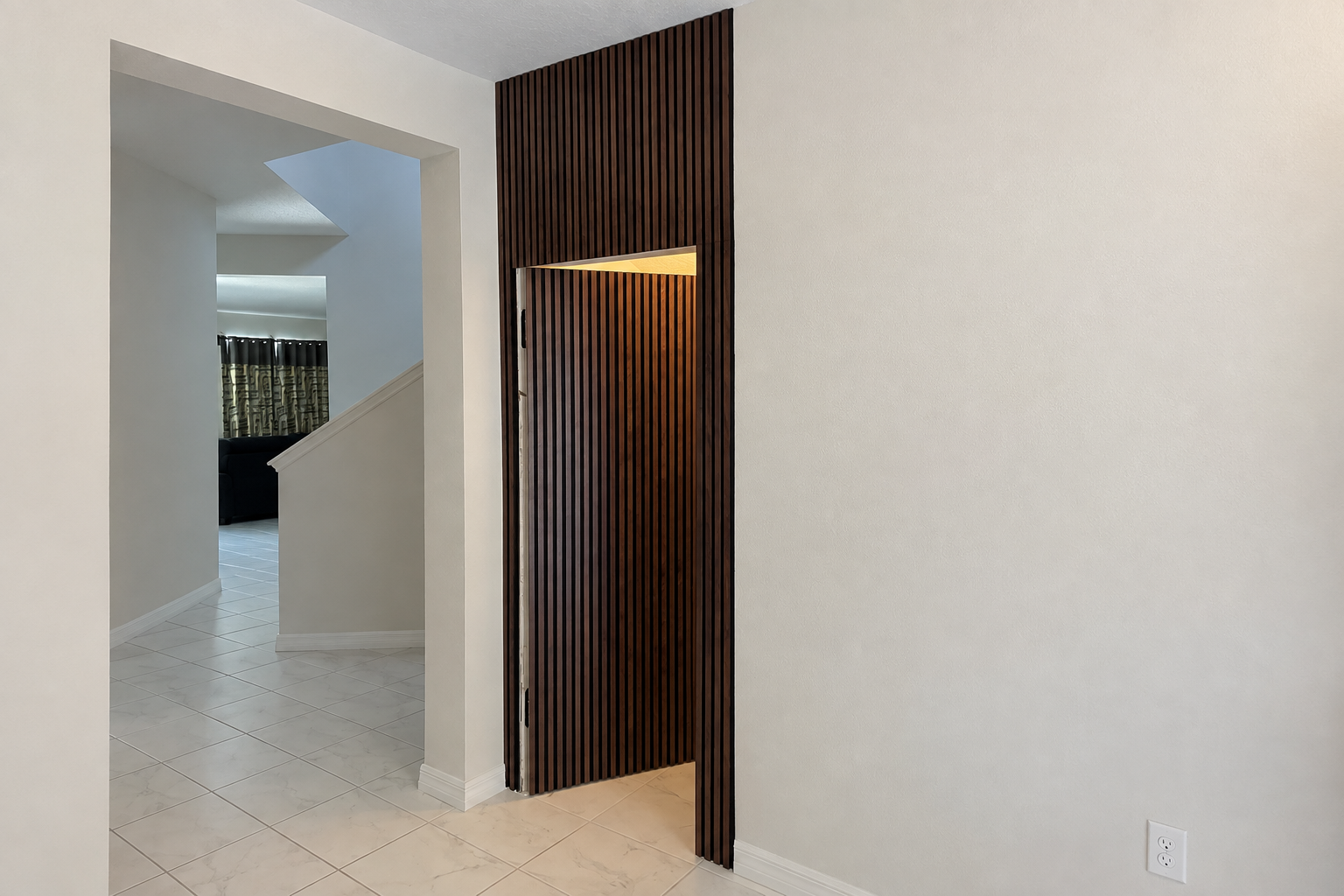 Hidden interior door blended into a paneled wall