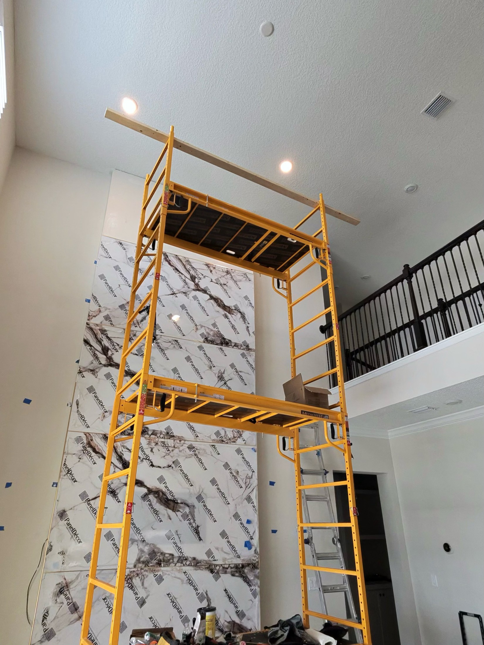 Marble-look panels being fitted to the central section while protective film remains on the surface