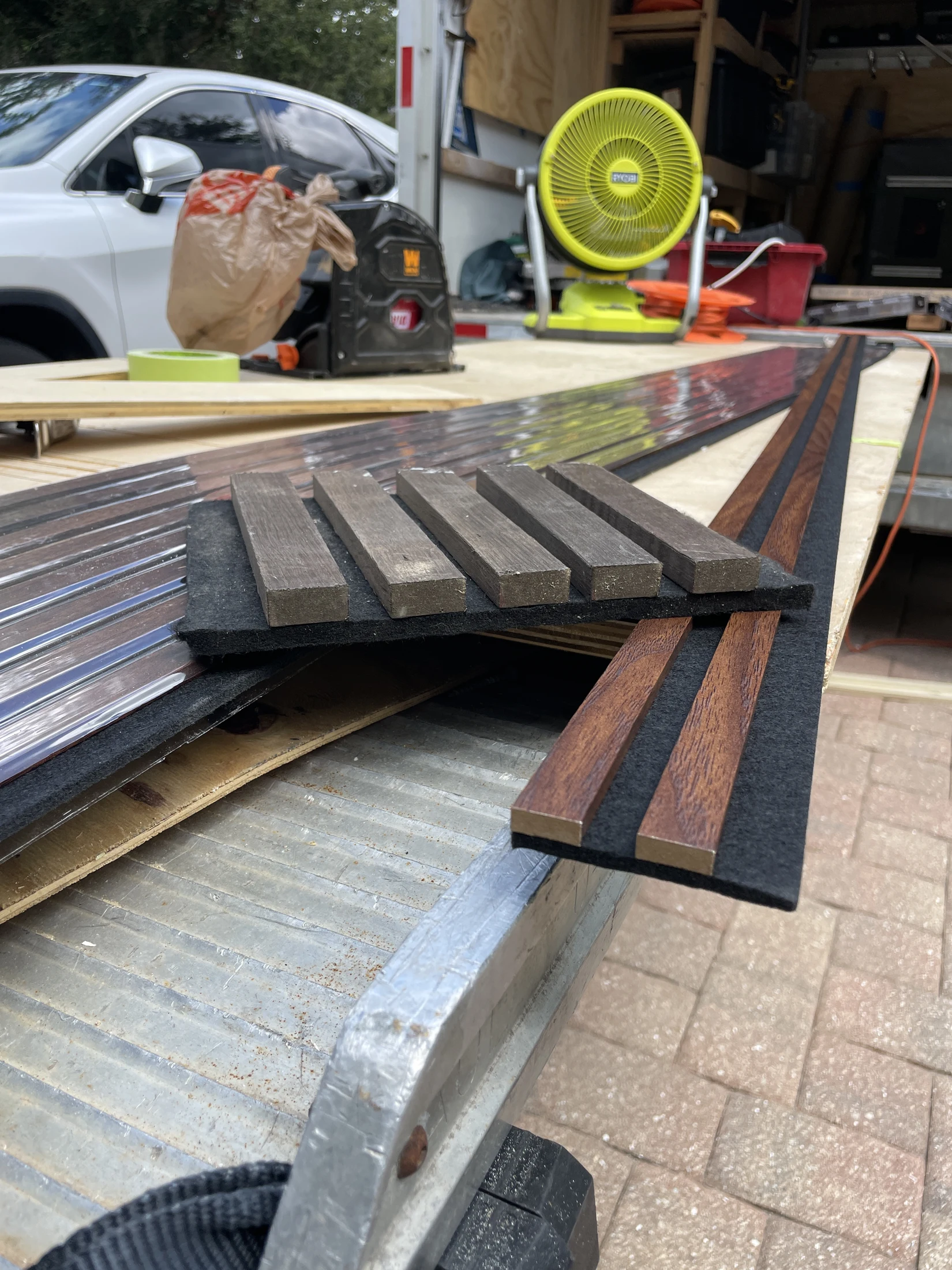 Wood-look slat panel sections laid out on a work surface during the project