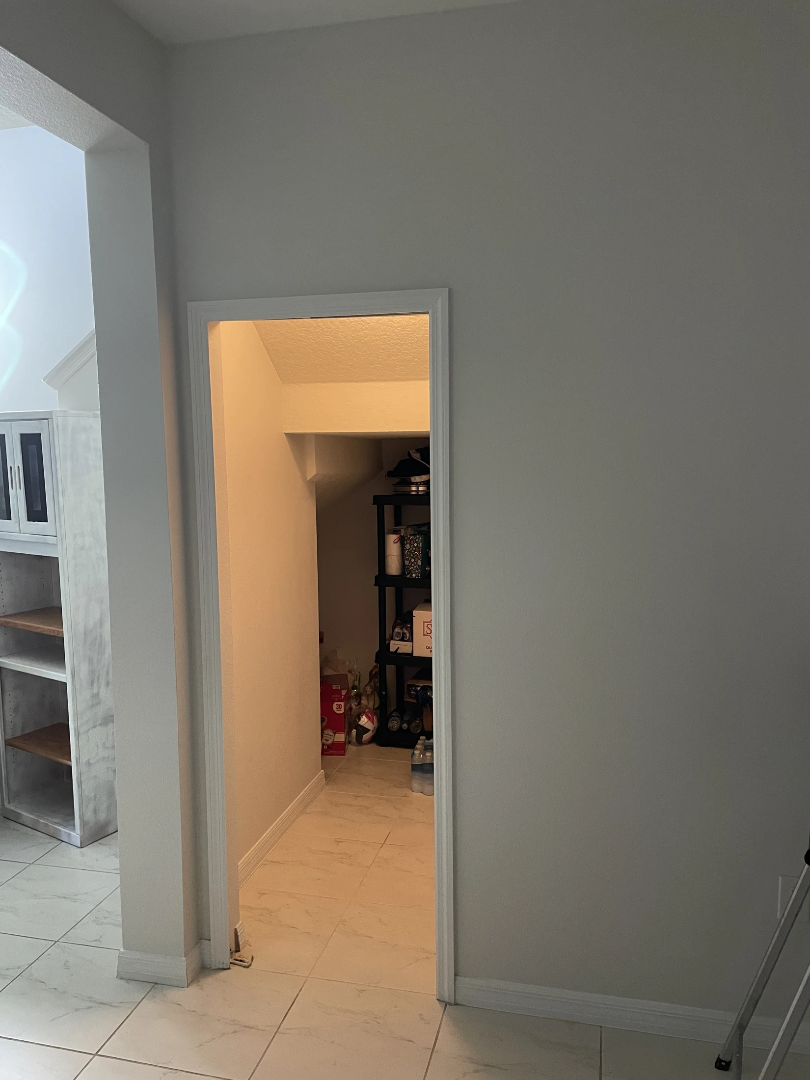 Original doorway beside a staircase before the hidden-door installation