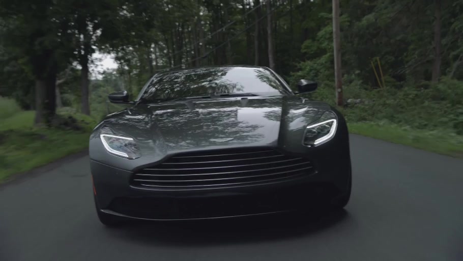 Aston Martin driving through woodland, still from the Because film