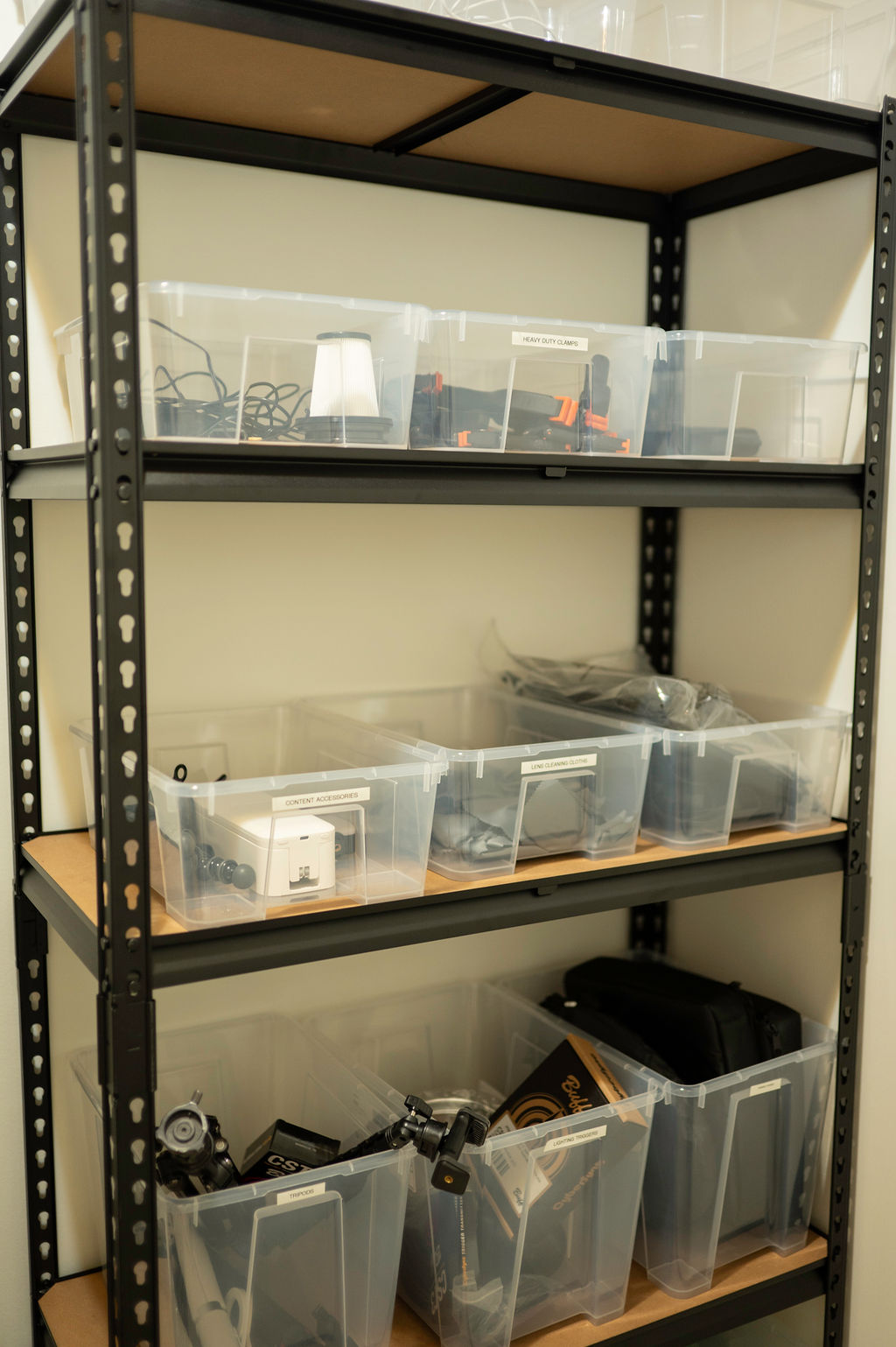 Shelves of grip gear, clamps and cables in labeled bins