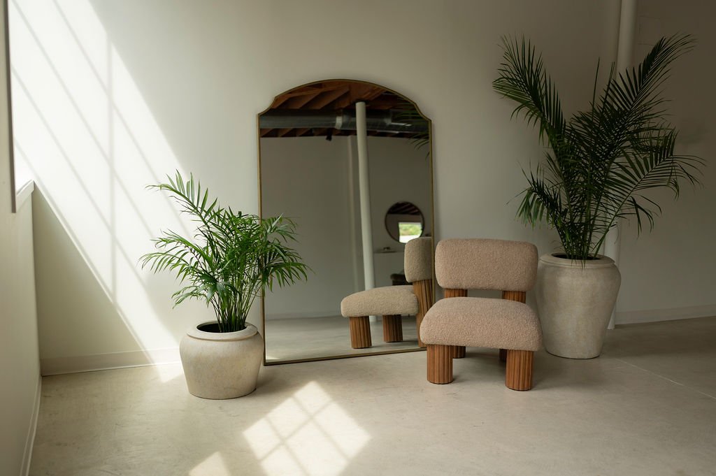 West Edit, arched mirror and boucle chair in afternoon light