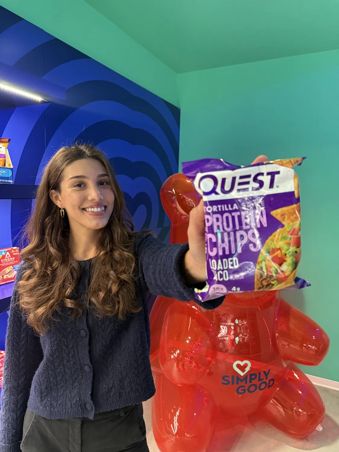 Xitllali at Simply Good Foods holding a Quest product