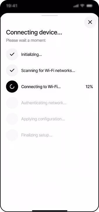 Mobile screen showing device connection progress with checked steps: Initializing and Scanning for Wi-Fi networks; currently connecting to Wi-Fi at 12%, with remaining steps grayed out: Authenticating network, Applying configuration, and Finalizing setup.