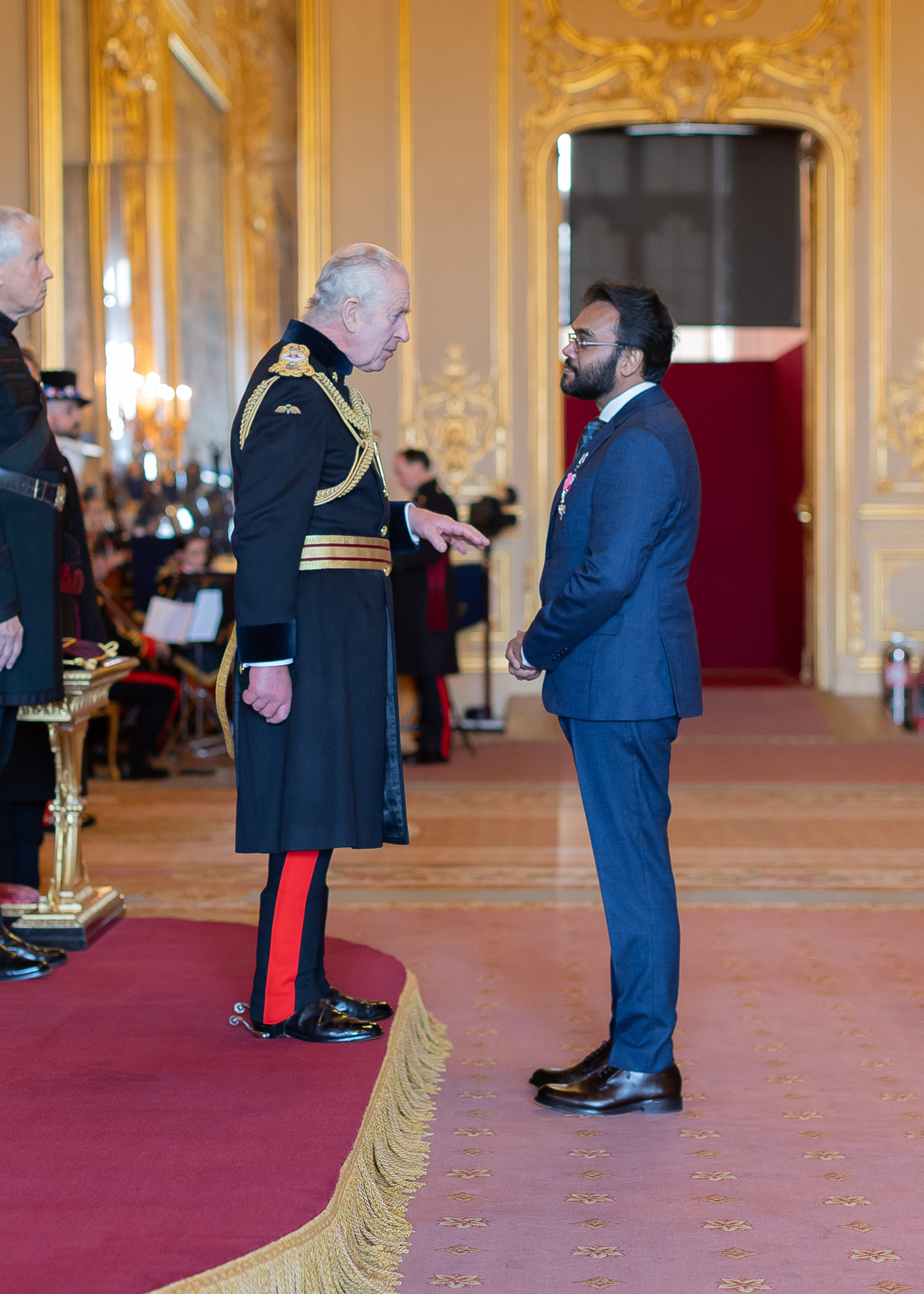 Professor Naseem Naqvi receiving his MBE from His Majesty King Charles III