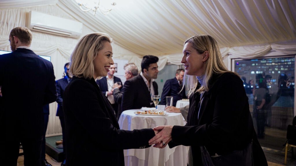 Attendees greeting one another during a BBA networking reception
