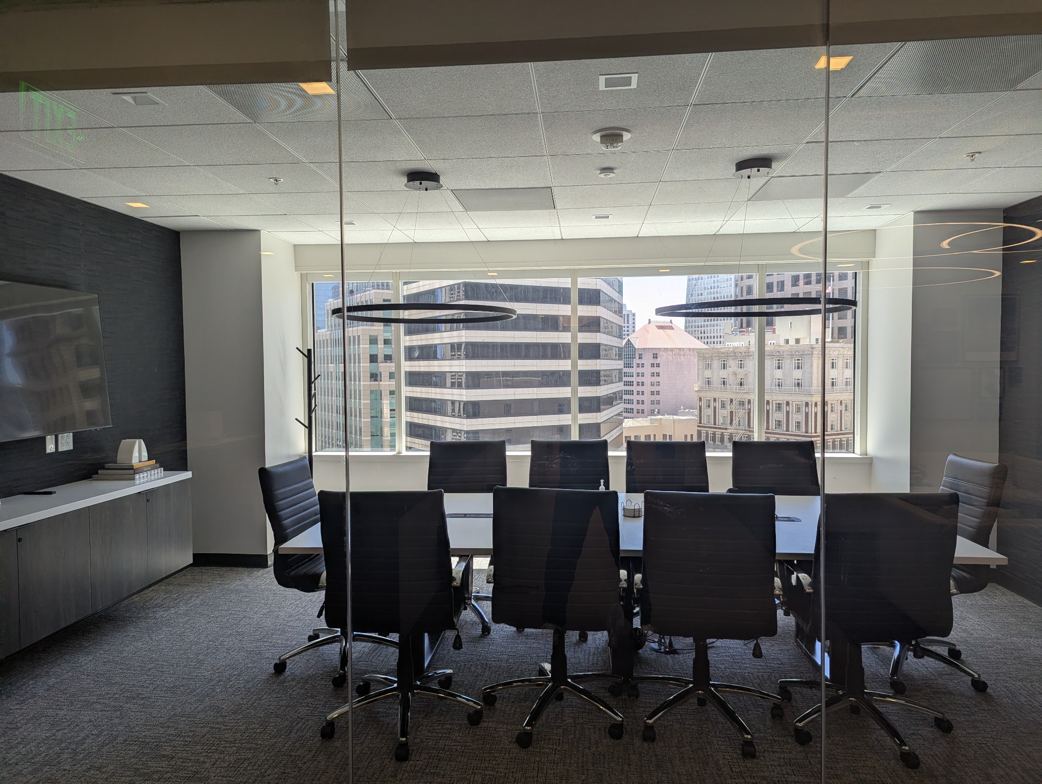 Glass-walled meeting room overlooking downtown San Francisco