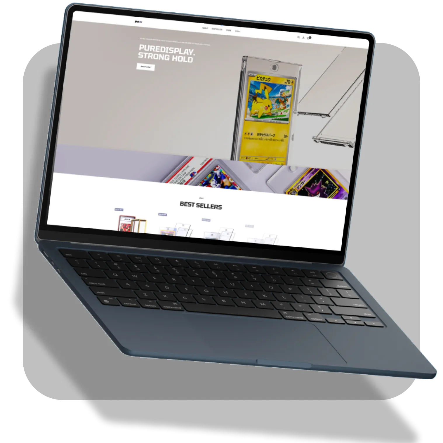 Sleek laptop with black keyboard displaying a website that features a Pikachu card case and text 'PureDisplay. Strong Hold.'