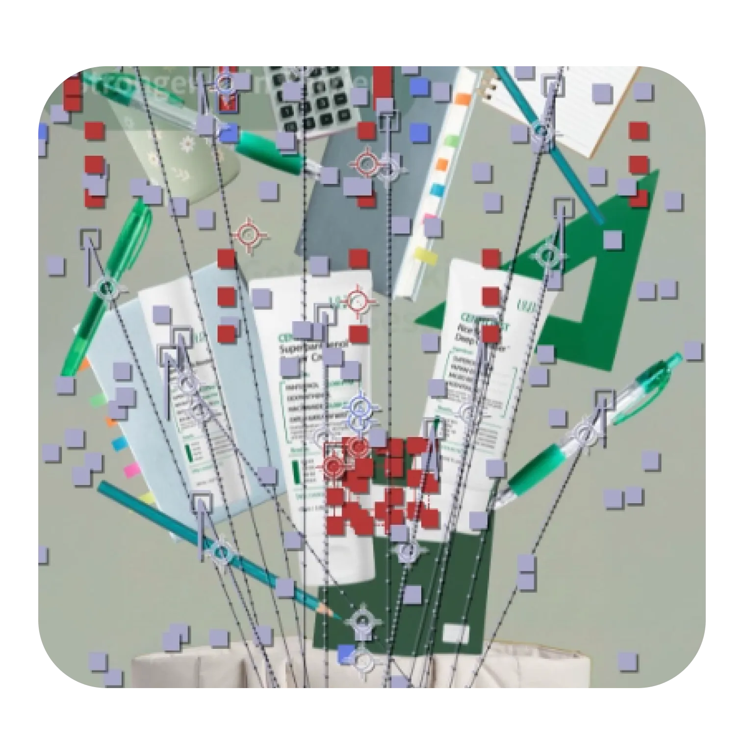 Top view of a collection of office and art supplies including two green pens, a pencil, a calculator, colored sticky tabs, a green triangular ruler, paper sheets, and three tubes of cream or glue arranged on a flat surface.