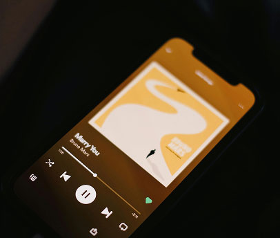 Smartphone displaying the song 'Marry You' by Bruno Mars on a music app with pause button active.